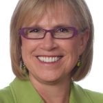 Picture of Jill Konrath in green shirt, purple-frame glasses